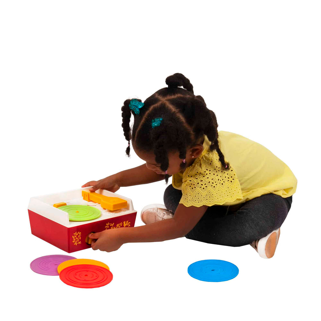 Lifestyle shot of girl playing with the Fisher-Price Music Box Record Player