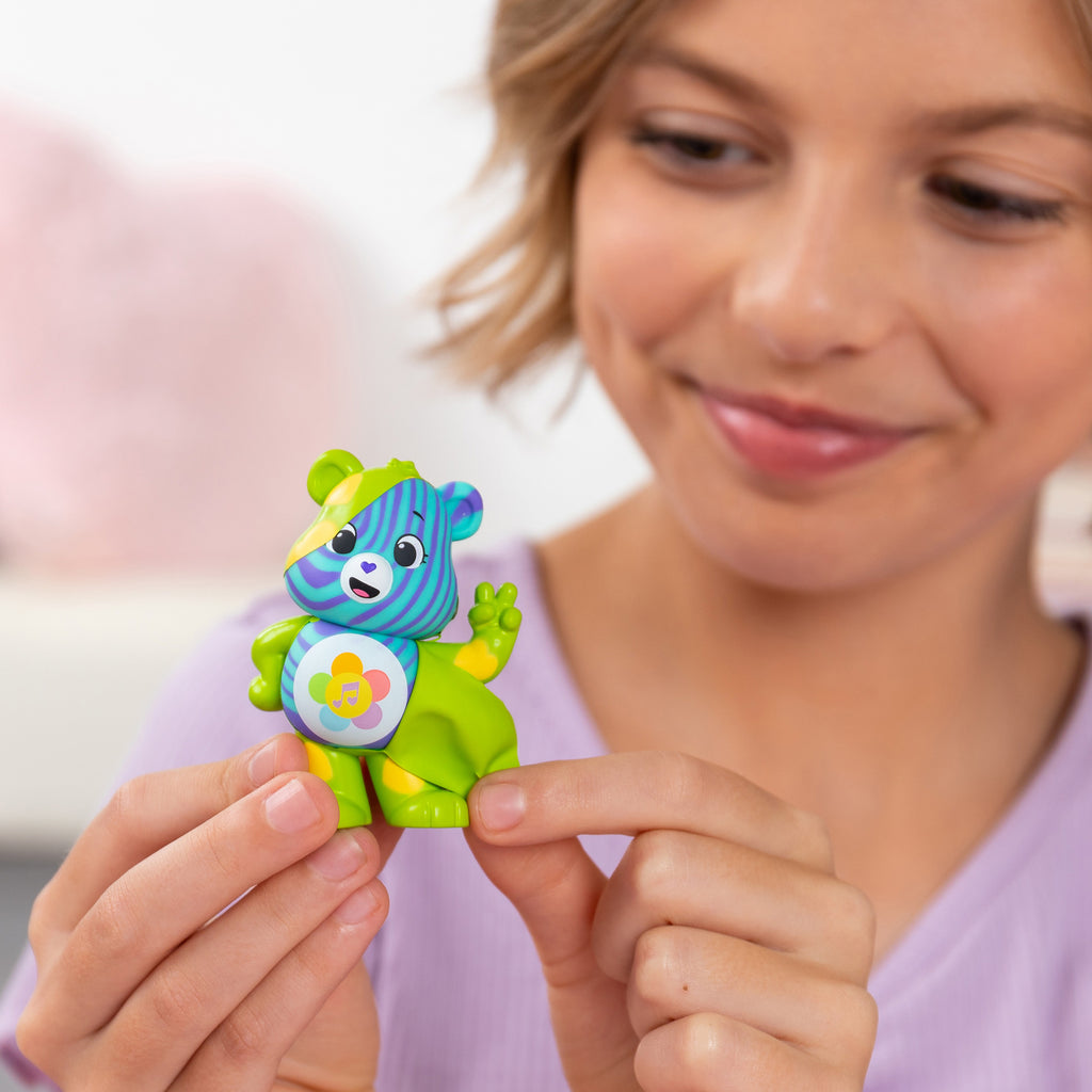 Care Bears Peel and Reveal - Close up Lifestyle shot of smiling girl peeling bear
