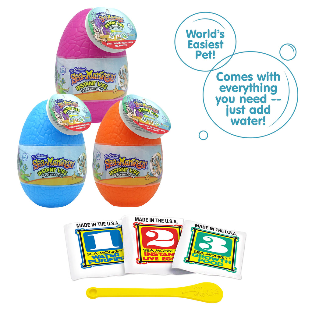 Three packets, numbered 1, 2, and 3 from left to right. There is a small yellow Sea-Monkeys spoon laying in front of the packets. There are two callouts in circles. One reads "World's Easiest Pet!" and the other reads "Comes with everything you need - just add water!"