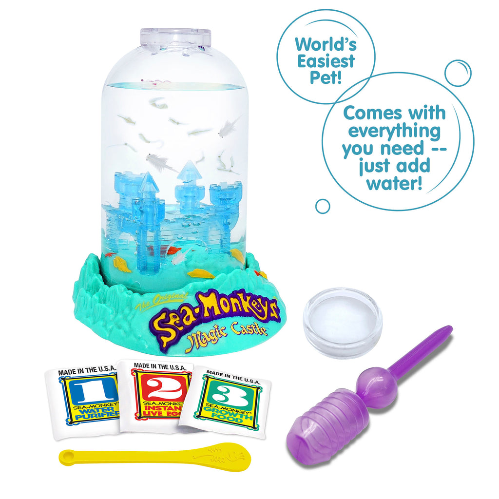 Three packets, numbered 1, 2, and 3 from left to right are vivble in front of the Magic Castle aquarium. There is a small yellow Sea-Monkeys spoon laying in front of the packets, and a purple pipette and clear circle magnifyer next to the spoon. There are two callouts in circles. They read "World's Easiest Pet!", and "Comes with everything you need -- just add water!"